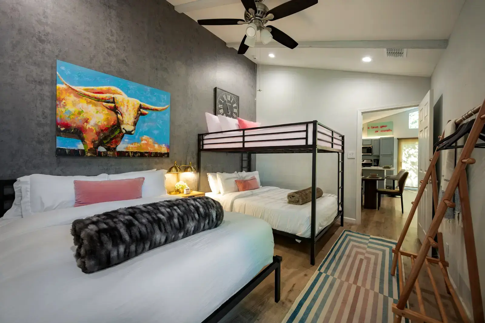 Bedroom with three queen beds including a bunk setup