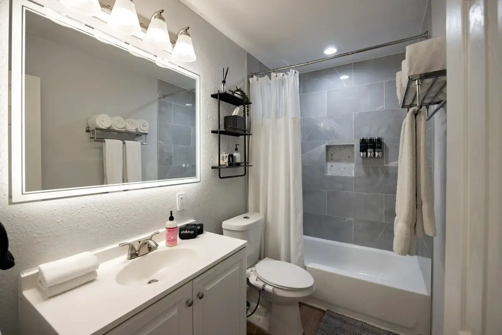 Bright full bathroom with shower and tub