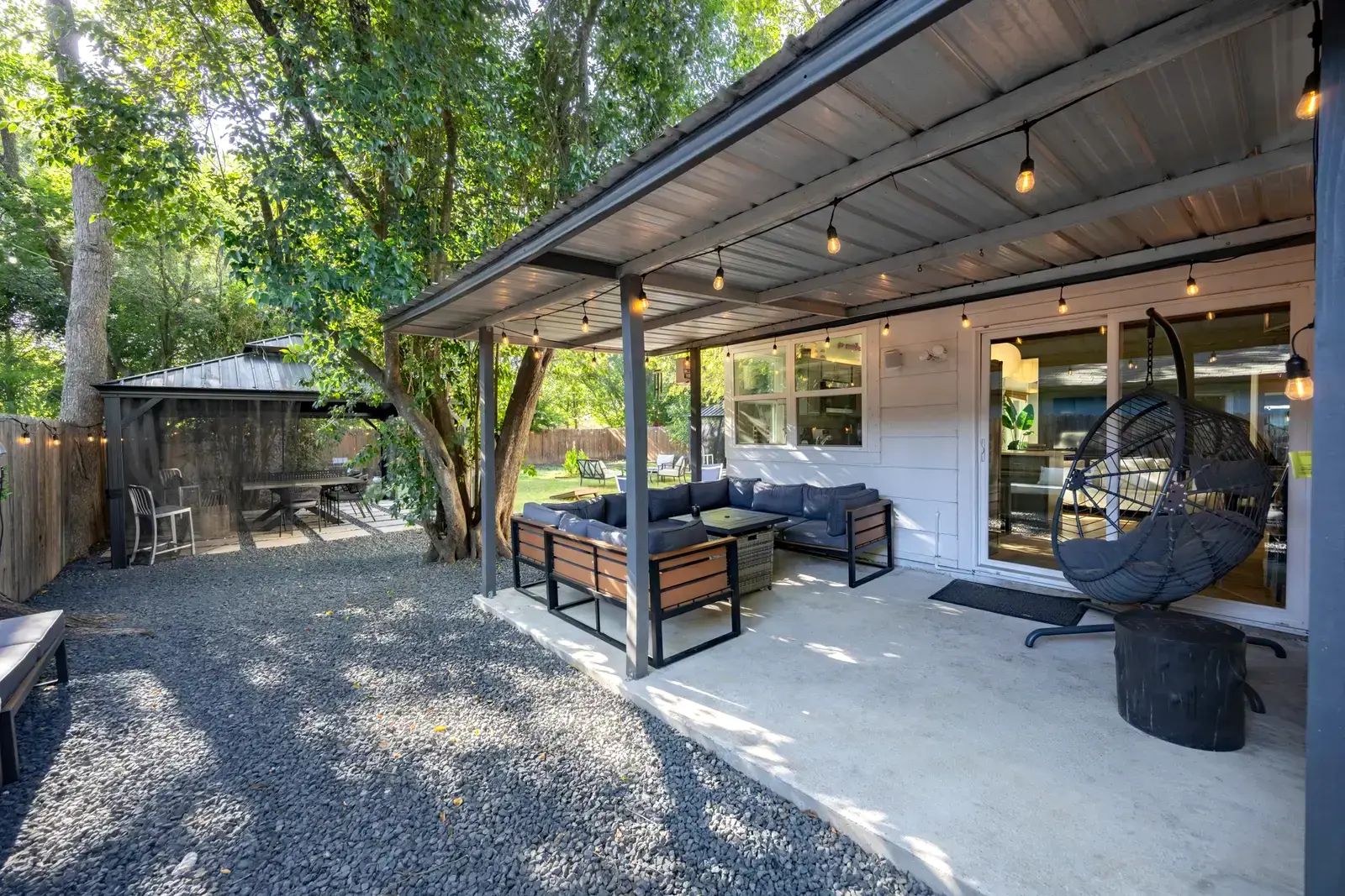 Covered outdoor lounge under string lights